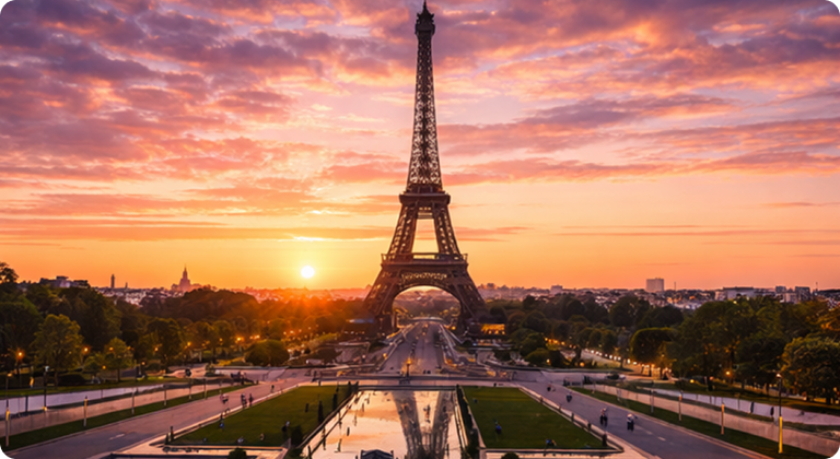 Eiffel Tower illuminated at sunset with Paris cityscape and gardens