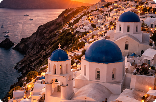 Santorini island with white buildings and blue domes overlooking the sea